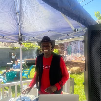 DJ EZ ED in cowboy hat at outdoor event